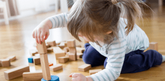 A child playing with wooden toys.