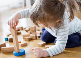 A child playing with wooden toys.