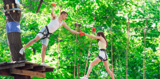 A couple completing a climbing rope course.