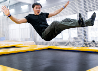 A man jumping on a trampoline.