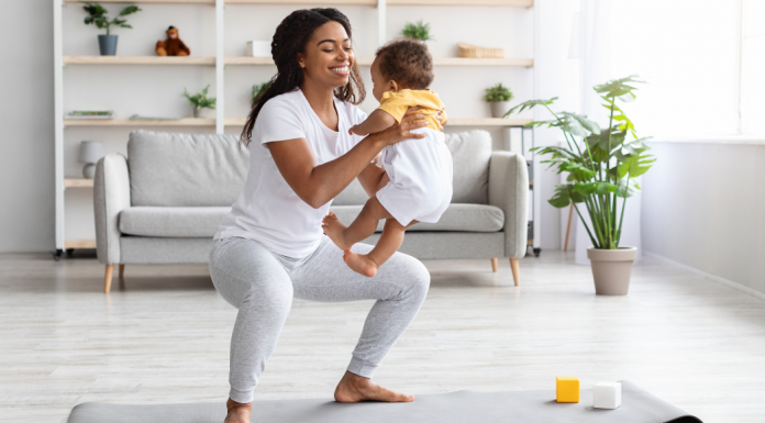 A woman working out with her baby.