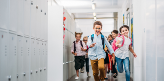 Kids running down the hallway at school.