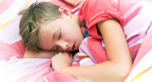A teenage boy sleeping.