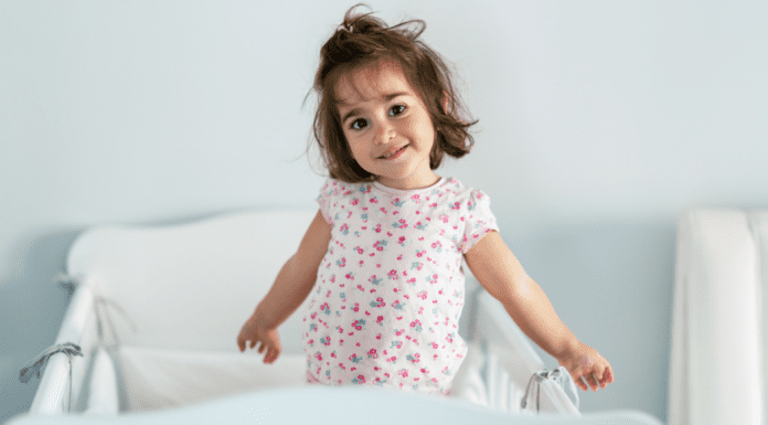 A toddler girl waking up early.