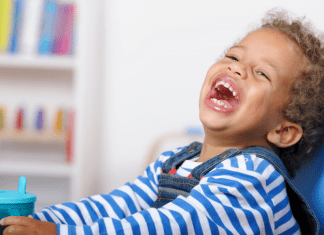 A toddler boy laughing