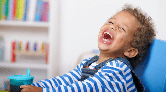 A toddler boy laughing