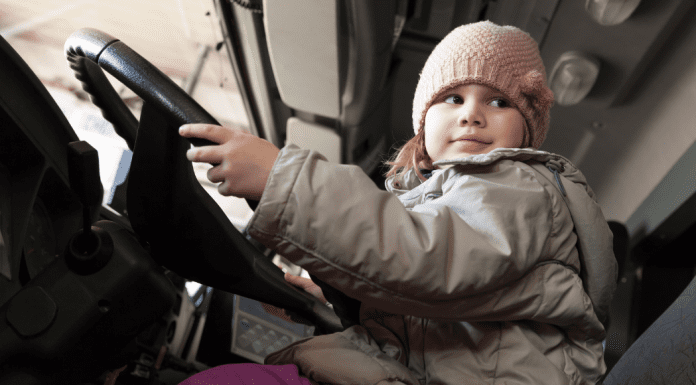 A toddler sitting in a truck.