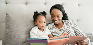 A mom reading to her toddler.