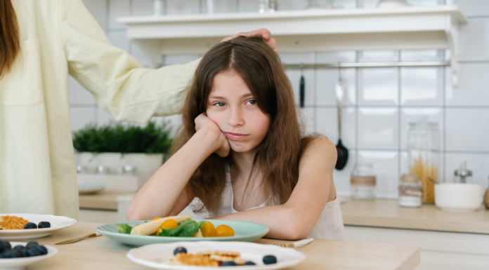 A girl not eating her dinner.