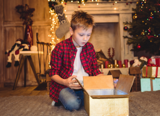A boy opening Christmas presents.