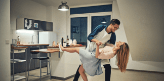 Date night in with a couple dancing in the kitchen.