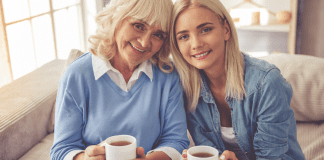 A mother and daughter drinking coffee.