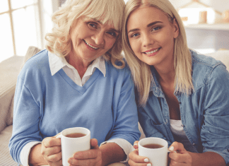 A mother and daughter drinking coffee.