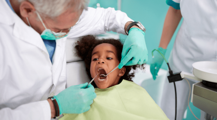 A kid sitting in the dentist chair.