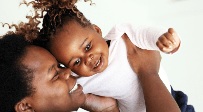 A mom holding her daugher.
