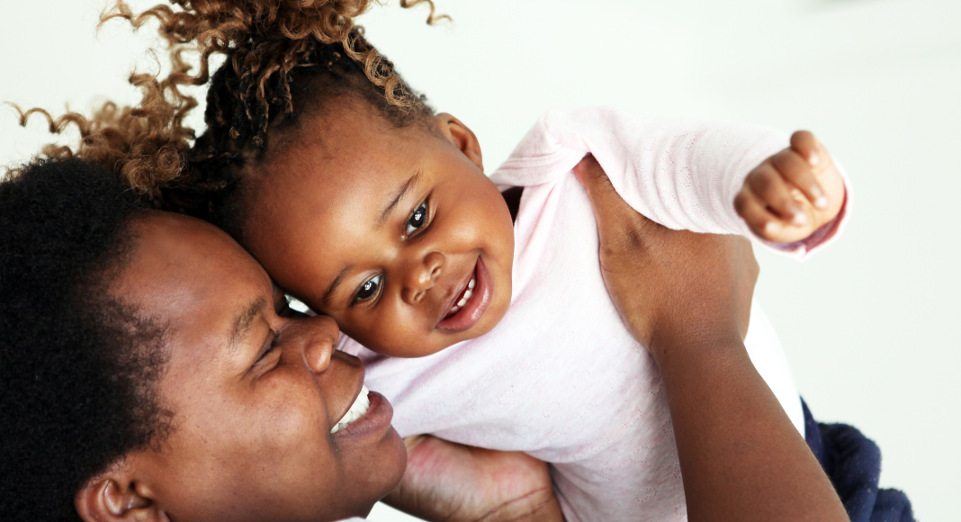 A mom holding her daugher.