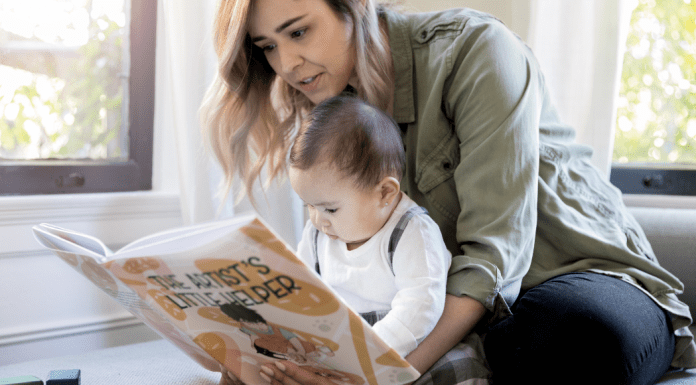 A mom reading a book to her baby.