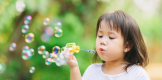 A girl blowing bubbles.