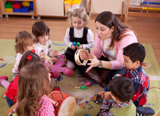 A preschool class sitting in a circle.