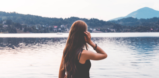 A woman looking at a lake.