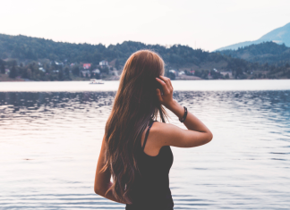 A woman looking at a lake.