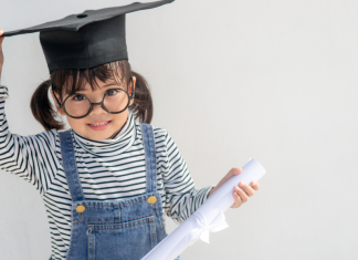 A preschooler wearing a graduation cap.