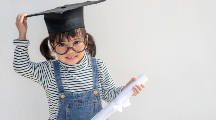 A preschooler wearing a graduation cap.