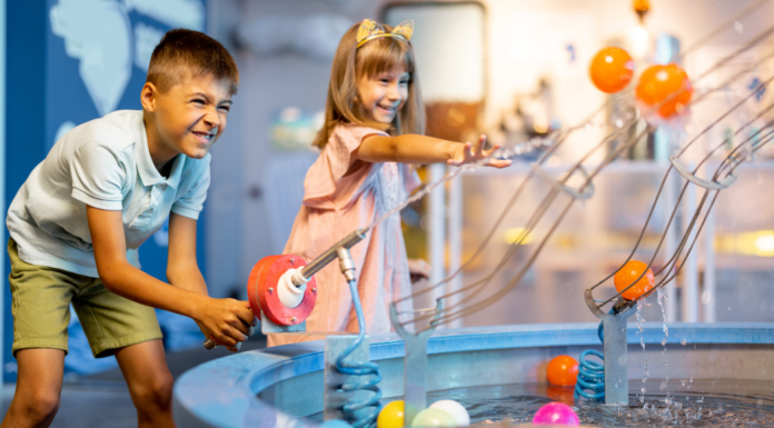Kids playing in an indoor water exhibit.