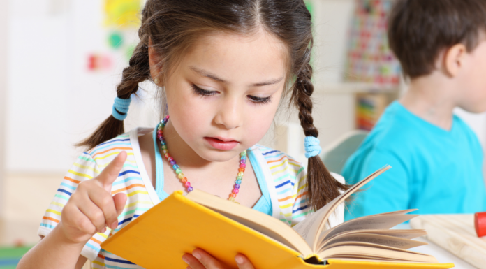 Reading Round-Up A girl reading a book.