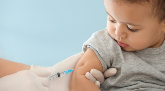 A toddler boy getting a vaccine.