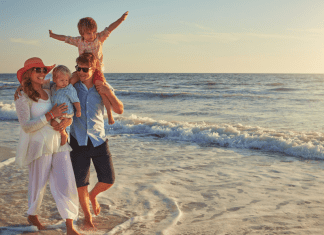 A family walking on a beach.