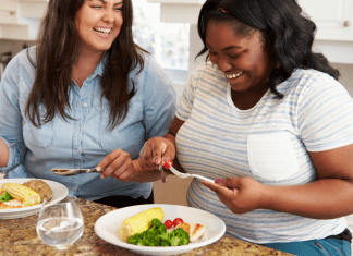 Two women eating a healthy meal.