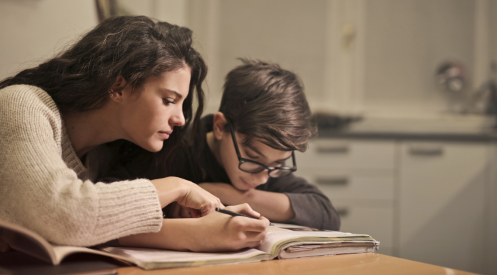 Mother helping son with homework.