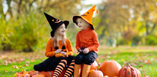 Girls dressed as witches and pumpkins for Halloween.