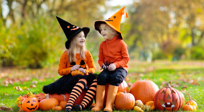 Girls dressed as witches and pumpkins for Halloween.