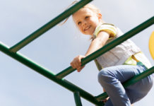 A girl climbing on the playground.