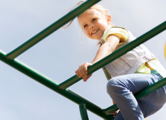 Girl on Fire: Why Gender Shouldn’t Define My Daughter A girl climbing on the playground.