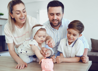 A family putting money in a piggy bank.
