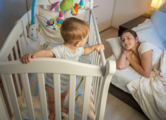 The 18-Month Sleep Regression A mom sleeping in her baby's room to get him to sleep.