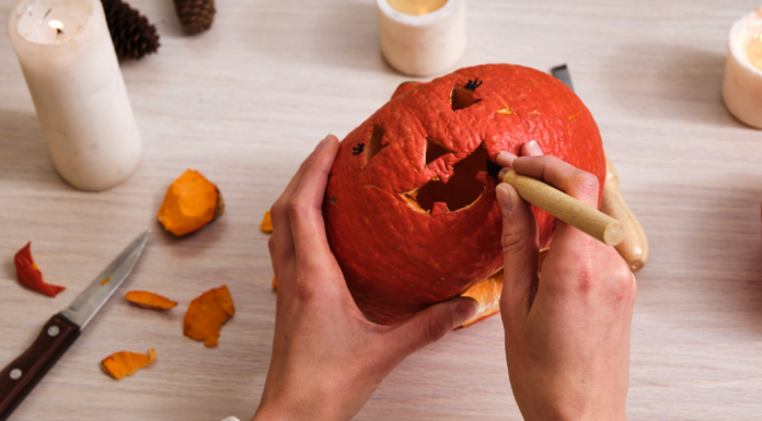 Carving a pumpkin.