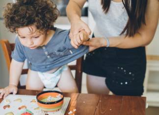 Expectations vs. Reality A mom trying to clean up her toddler boy.