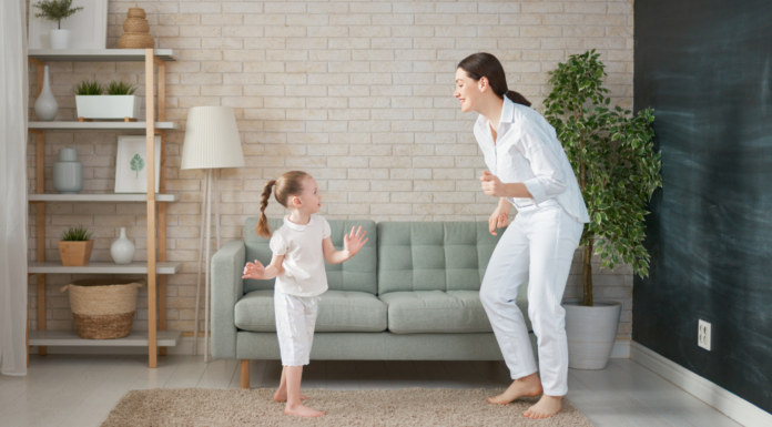 A mom and daughter dancing.