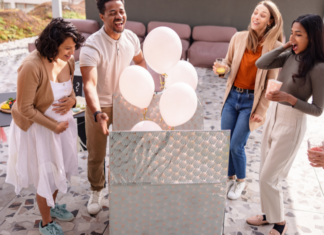 Boy or Girl? Making the Big Reveal A couple finding out the gender of their baby with balloons.