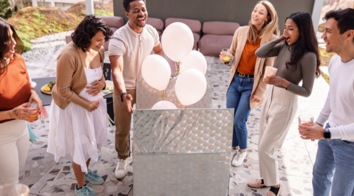 A couple finding out the gender of their baby with balloons.