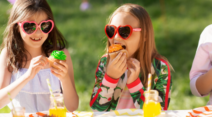 Girls eating cupcakes at a birthday party.