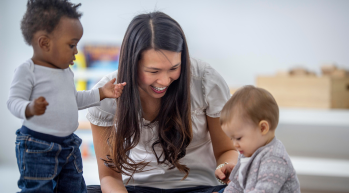 A woman taking care of two children.