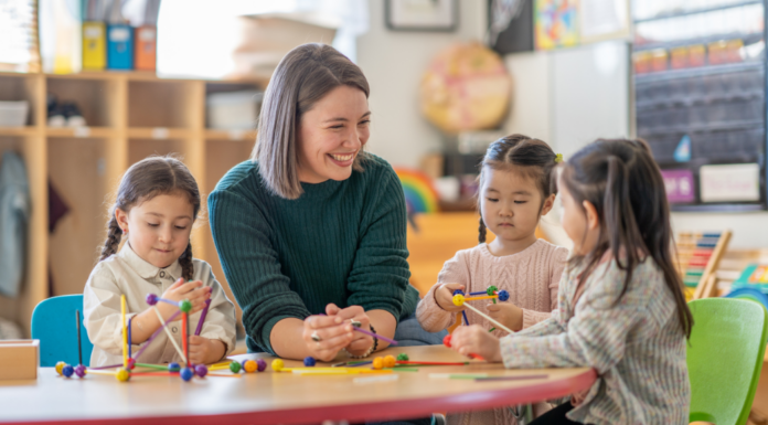A kindergarten teacher with three students.