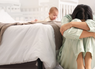 A woman struggling after having a baby.
