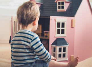My Boys Play With Dolls {and why yours should too} A boy playing with a dollhouse.