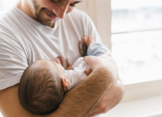 A dad holding his baby.